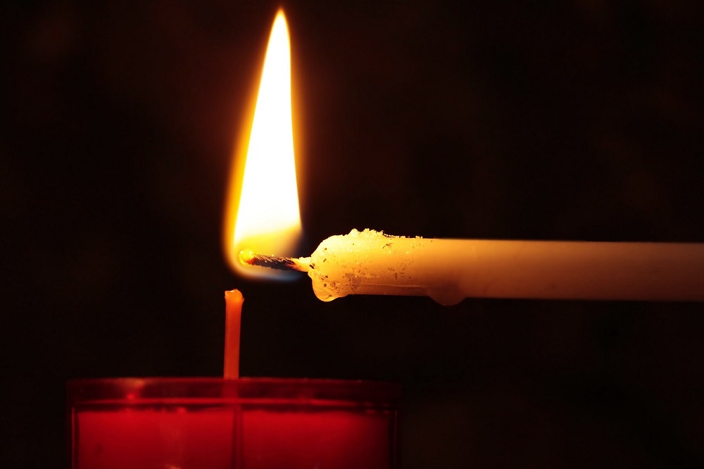 Why lighting up a candle in church?